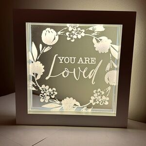 Hangable decorative lighted “You are Loved” art.